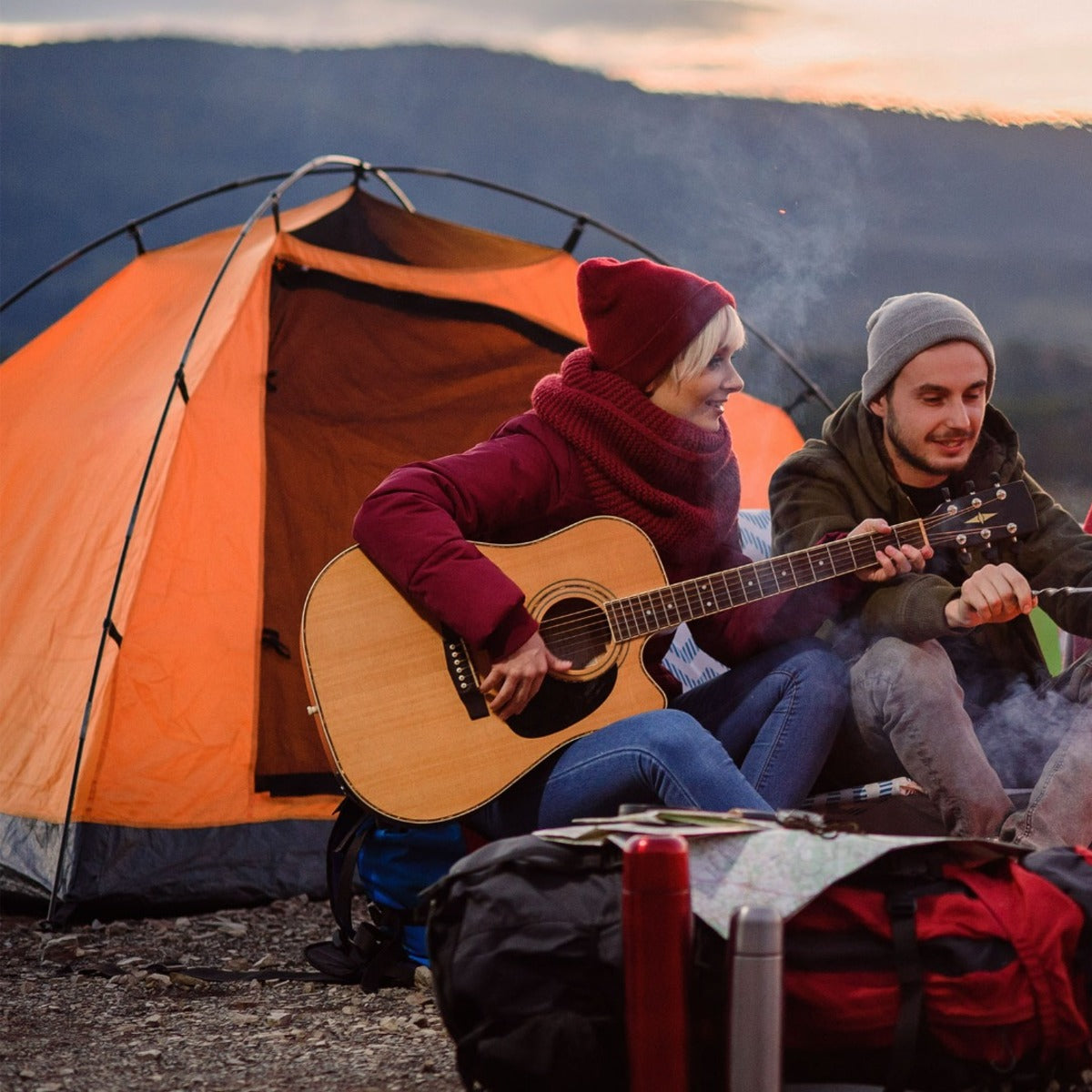 Friends sharing an evening at a mountain campsite